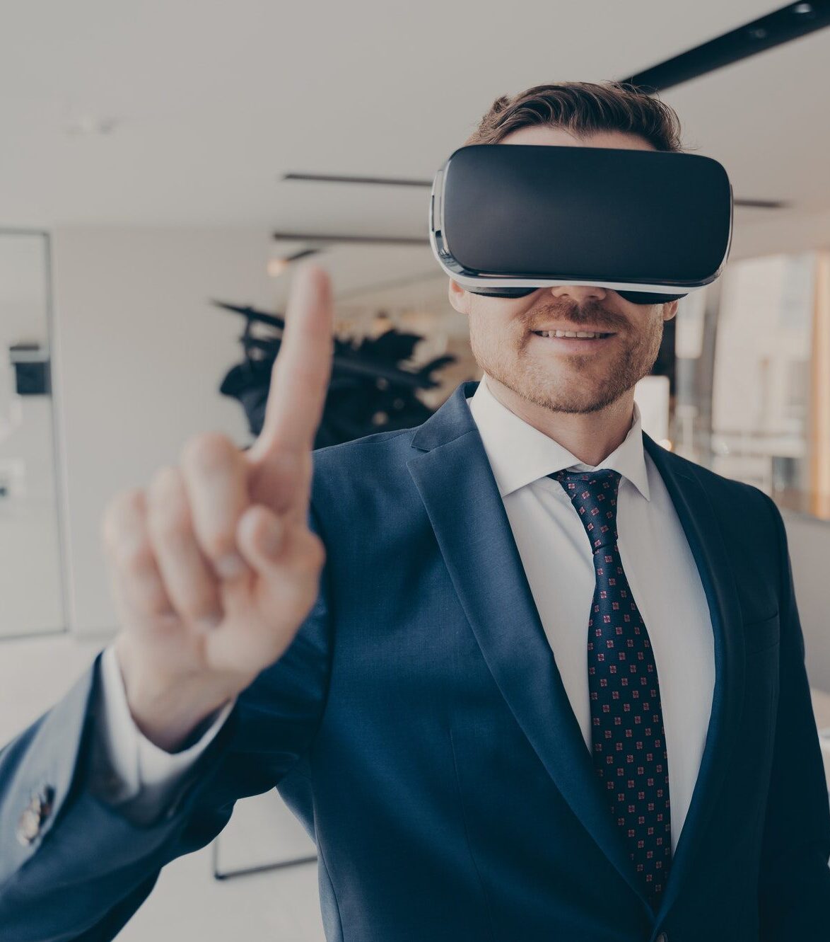 CEO man stands in office with VR headset and interacts with application virtual interface